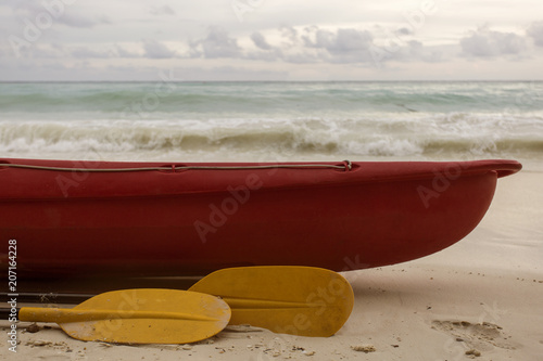 red boat and yellow paddle, seaside landscape
