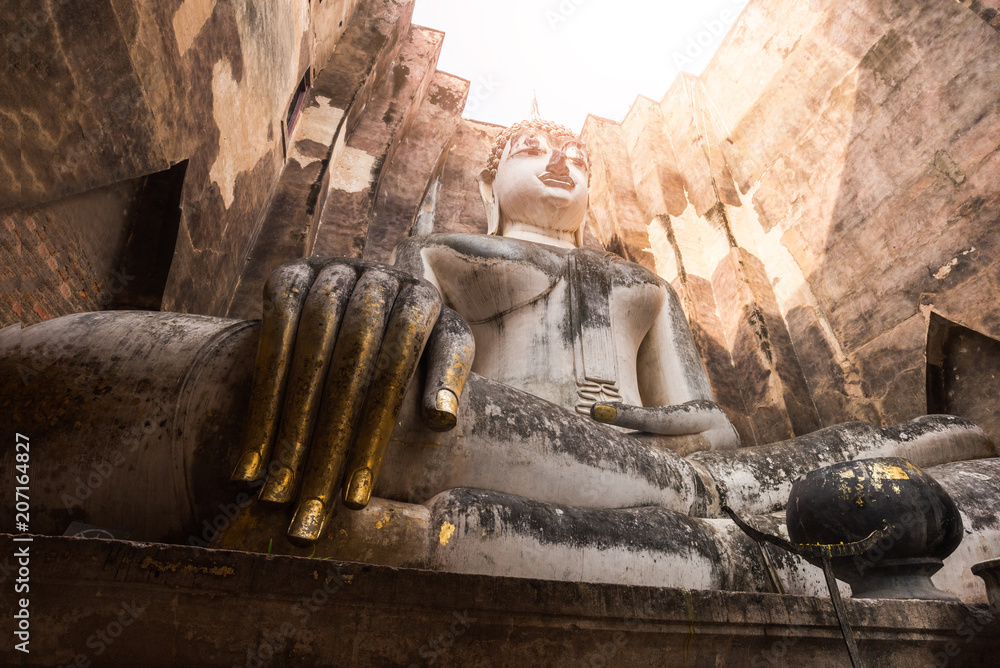 Big Ancient Buddha statue is sitting, beautiful. And is very respectful of wat wi whum temple in the sukhothai historical park area.a UNESCO world heritage site ,Sukhothai, Thailand - obrazy, fototapety, plakaty 