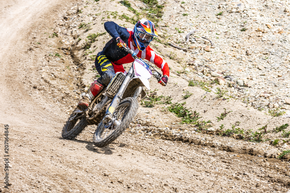Professional Motocross Motorcycle Rider Drives Over the Road Track. Professional Motocross Motorcycle Rider Drives Over the Road Track.