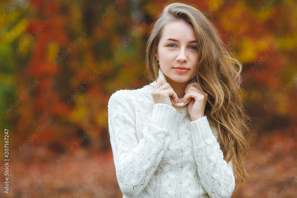 Young attractive woman in autumn colorful background