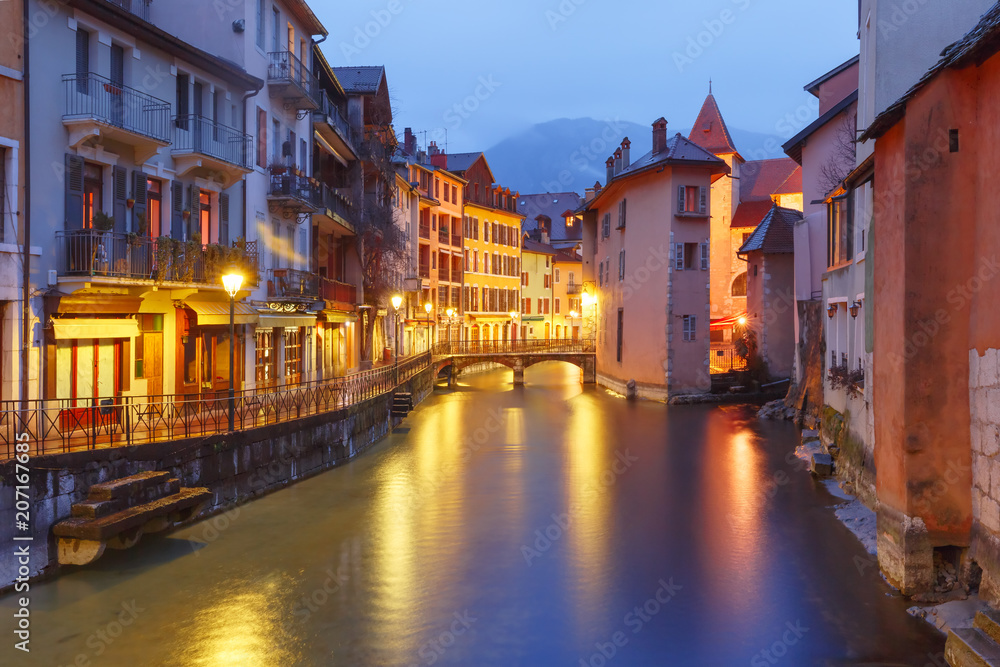 The Palais de l'Isle and Thiou river during morning blue hour in old city of Annecy, Venice of the Alps, France