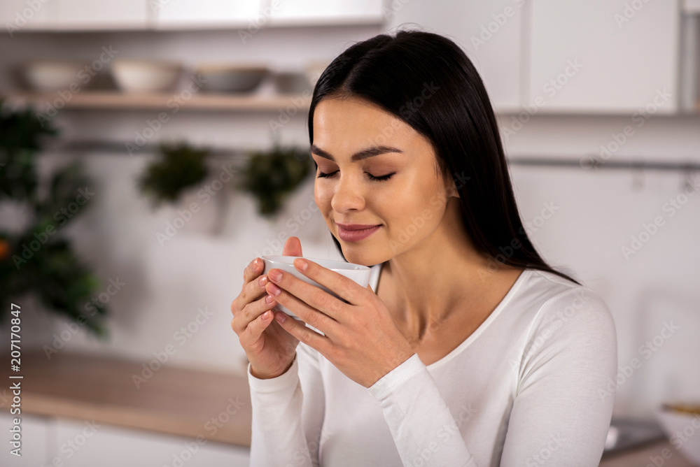 Nice young woman enjoying her cup of tea Nice young woman enjoying her cup of tea