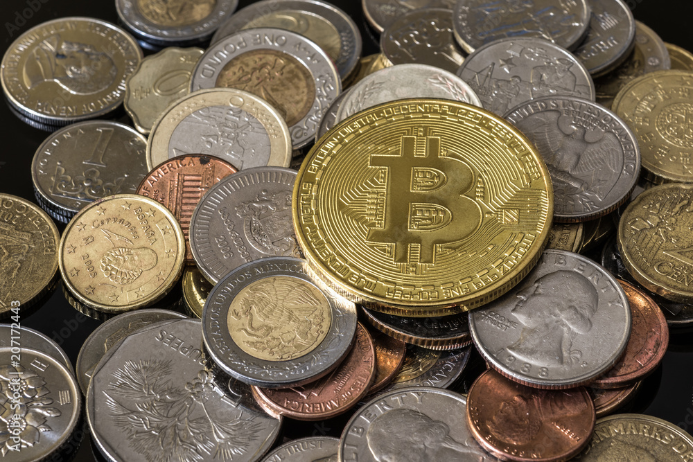Golden bitcoin over a pile of coins. Golden bitcoin over a pile of coins.