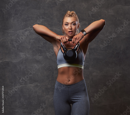 Wallpaper Mural Beautifull fitness woman in gray sportswear doing exercise with dumbbells in the fitness center. Torontodigital.ca