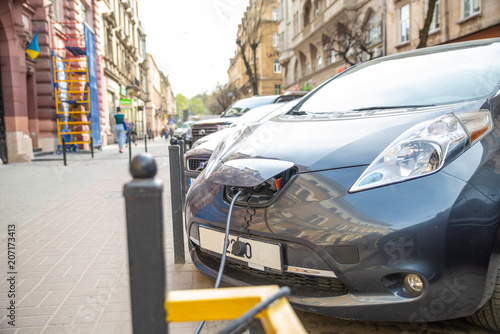 electric car charging on city street parking
