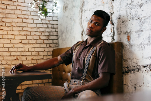 Stylish male in classic clothes sitting in cafe photo