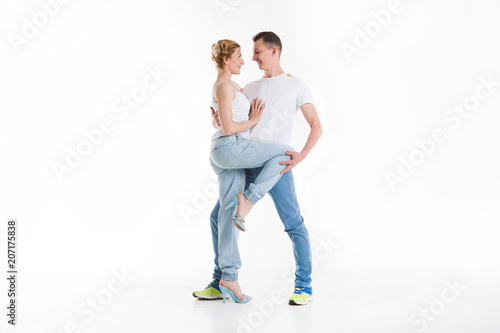 beauty couple dancing on grey background.