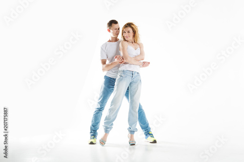 beauty couple dancing on grey background.