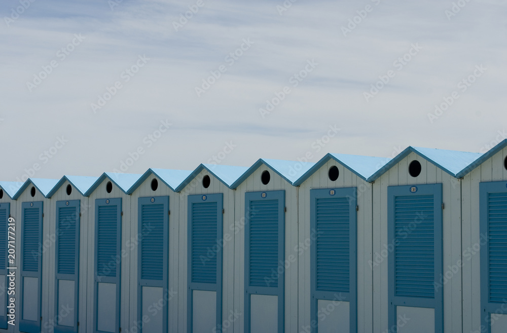 wooden beach cabins by the sea, changing rooms, blue and white, used to change and put on bathing suit, vacation, summer, sun, ligurian riviera, Albenga beach, Italy wooden beach cabins by the sea, changing rooms, blue and white, used to change and put on bathing suit, vacation, summer, sun, ligurian riviera, Albenga beach, Italy