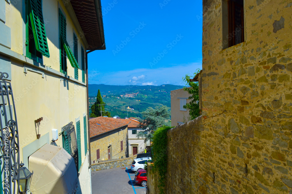 Small, narrow and colored street in Fiesole, Italy