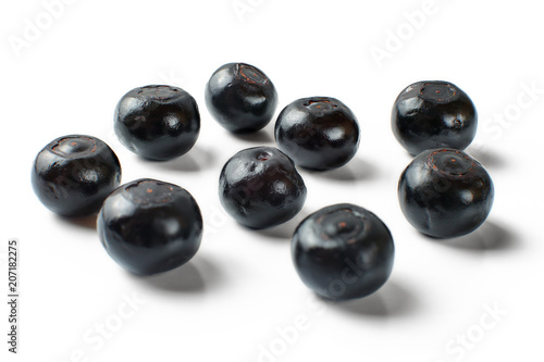 Couple of glossy wet blueberries isolated on white background.