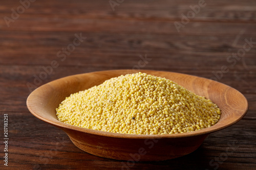 A wooden dish with lentils on rustic wooden background, top view, close-up, selective focus.
