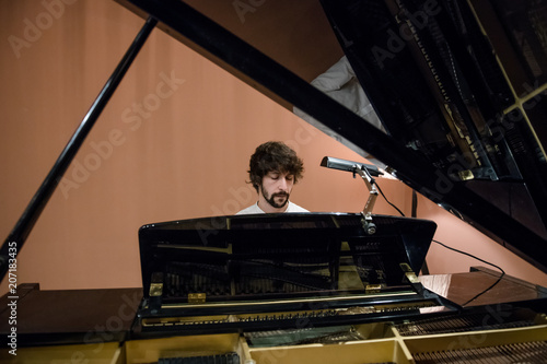 Man playing piano in studio photo