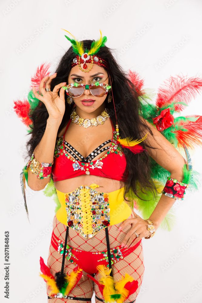 Very fit young hispanic woman in Carnaval costume and athletic shoes posing  on clean white background Stock Photo | Adobe Stock