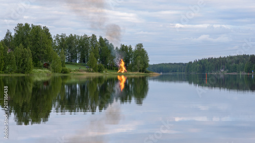 Finland. Midsummer feast, bonfire and lake