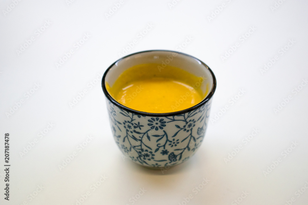 Creamy pumpkin soup on white tabletop