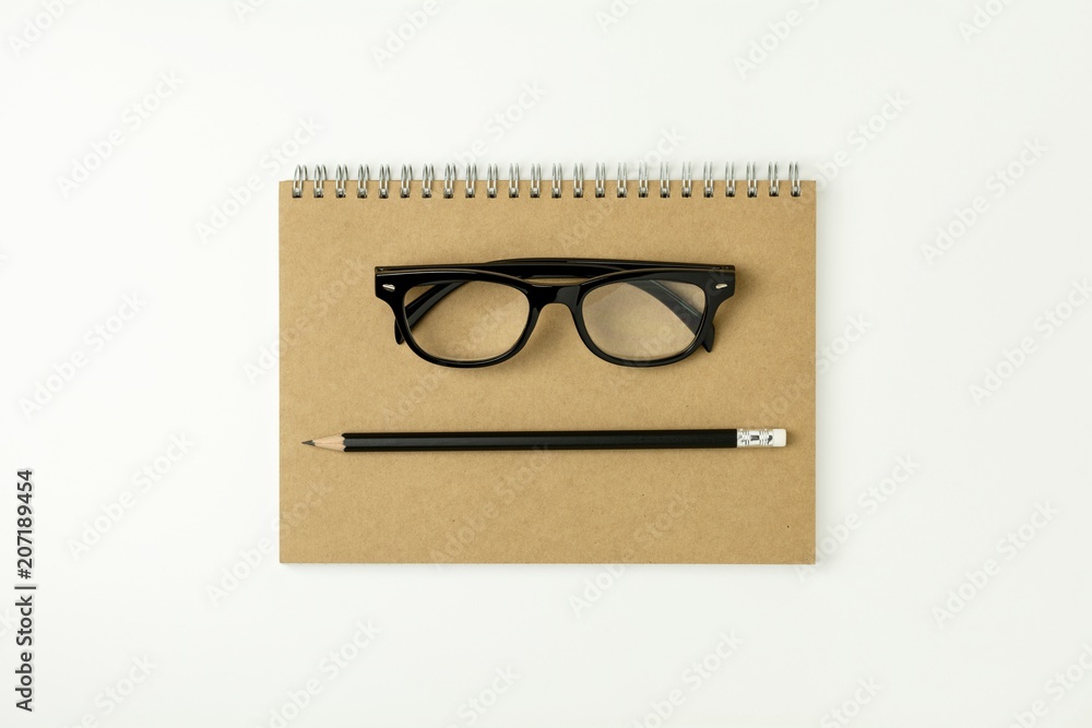 glasses, pencil on a notebook - for business concept background glasses, pencil on a notebook - for business concept background