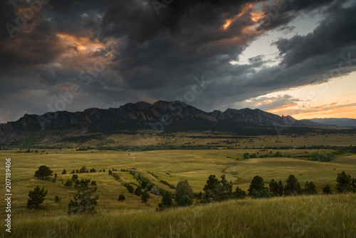 Dark clouds rolling over the Flatirons in Boulder, Colorado during sunset.  © Rosemary