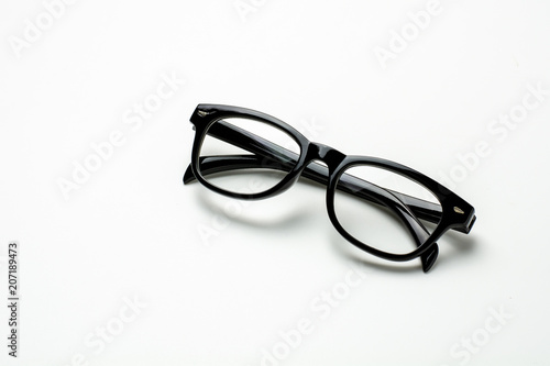 black plastic glasses and a shadow on white background