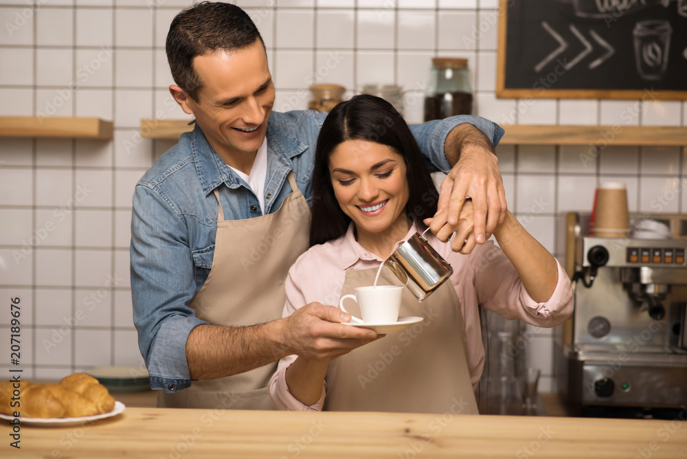 couple in aprons preparing coffee couple in aprons preparing coffee