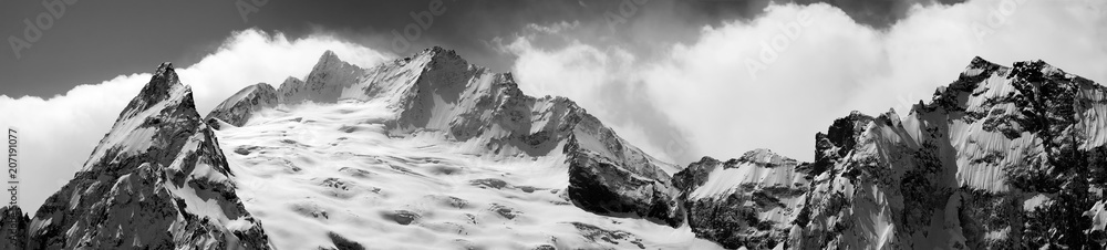 Black and white panoramic view on snowy glacier and mountain peak