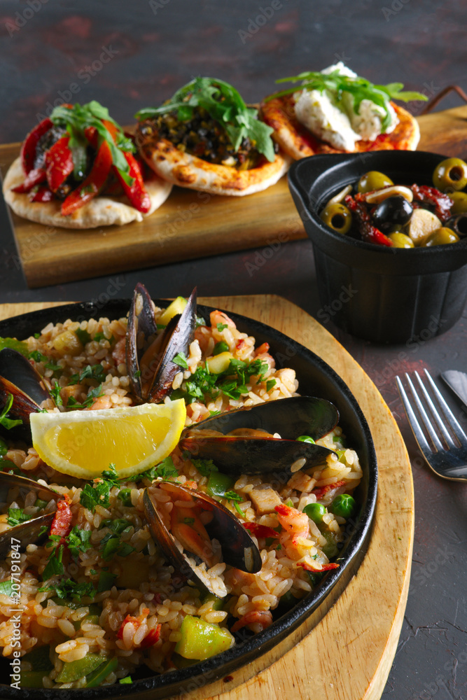 Set of tapas and paella with shrimps and mussels Set of tapas and paella with shrimps and mussels