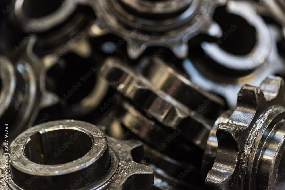 Background made of black spur gears or cogwheels Background made of black spur gears or cogwheels