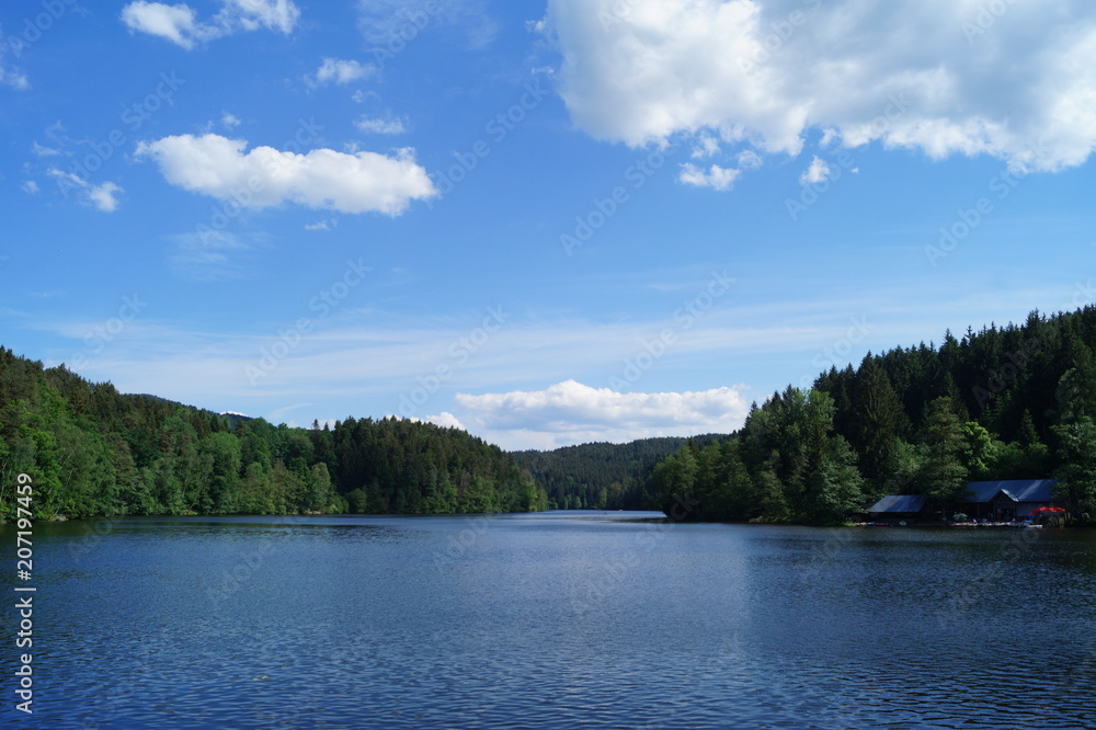 a lake in the depths of forests with a small quay