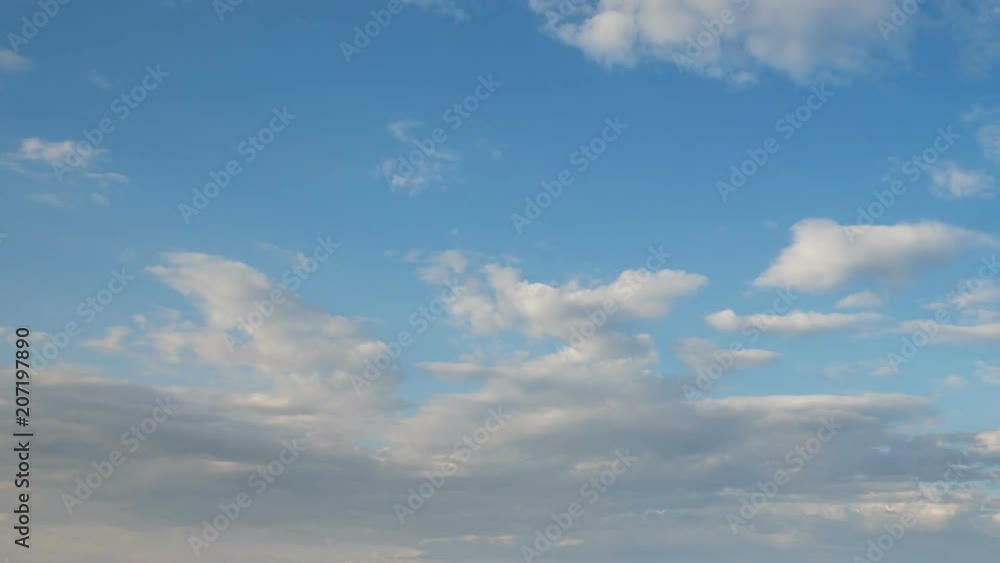Russia, time lapse. Formation and rapid movement of white clouds of different shapes in the blue sky in late spring at sunset. Russia, time lapse. Formation and rapid movement of white clouds of different shapes in the blue sky in late spring at sunset.