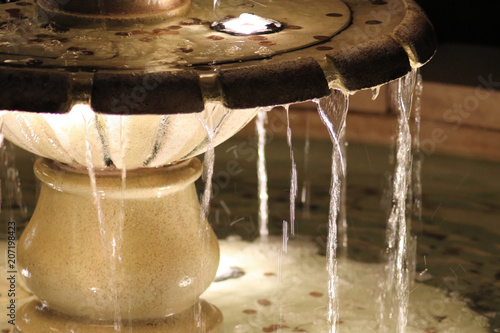 Fotografi Illuminated water fountain with coins