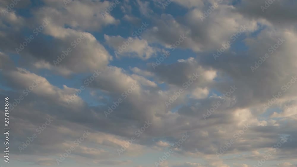 Russia, time lapse. Formation and rapid movement of white clouds of different shapes in the blue sky in late spring at sunset. Russia, time lapse. Formation and rapid movement of white clouds of different shapes in the blue sky in late spring at sunset.