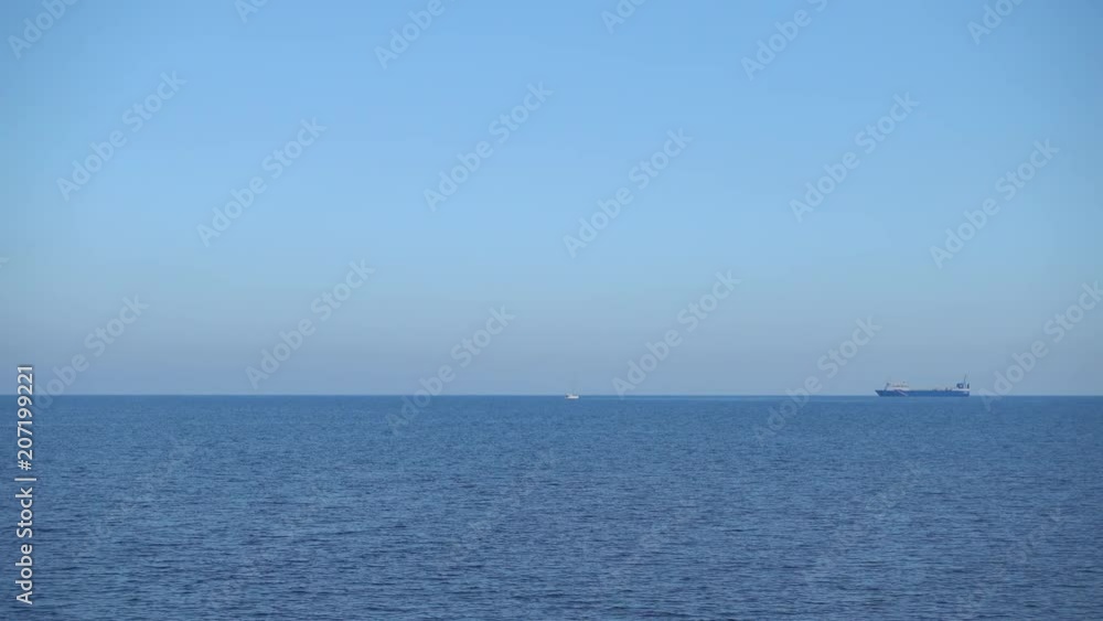 Small white yacht and big transcontinental ship in the sea. Small white yacht and big transcontinental ship in the sea.
