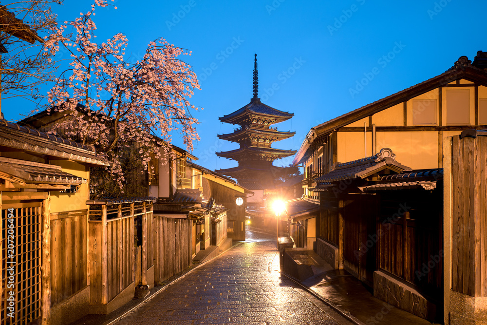 Japanese pagoda and old house with cherry blossom in Kyoto at twilight. Japanese pagoda and old house with cherry blossom in Kyoto at twilight.