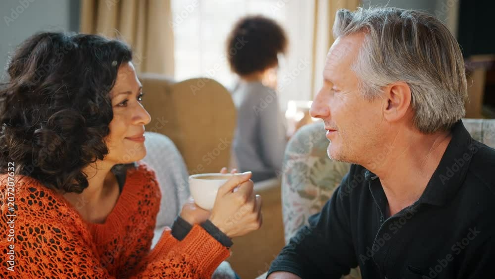 Middle Aged Couple Sitting Around Table In Coffee Shop Middle Aged Couple Sitting Around Table In Coffee Shop