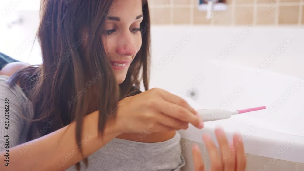 Couple Celebrating Positive Home Pregnancy Test Result Couple Celebrating Positive Home Pregnancy Test Result