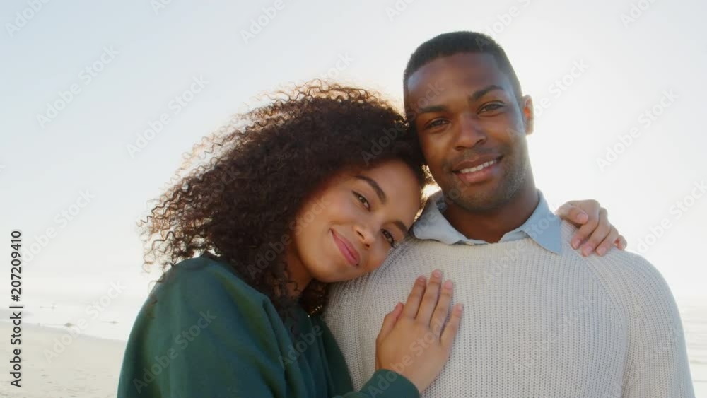 Portrait Of Romantic Couple On Winter Beach Vacation With Flare