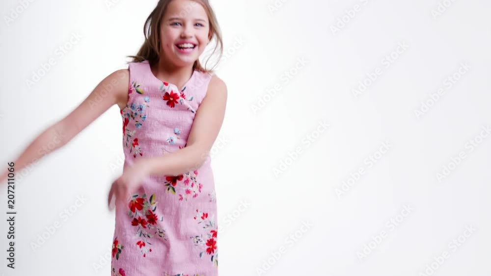 Girl Jumping And Posing Against White Studio Background Girl Jumping And Posing Against White Studio Background