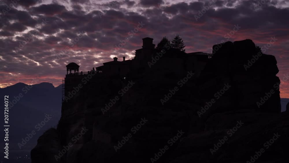 Scenic sunset dark evening sky over holy Varlaam monastery on cliff in Meteora, Thessaly Greece. Greek destinations. Time lapse Scenic sunset dark evening sky over holy Varlaam monastery on cliff in Meteora, Thessaly Greece. Greek destinations. Time lapse
