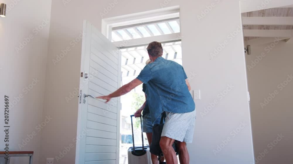 Excited Couple Arriving At Summer Vacation Rental Excited Couple Arriving At Summer Vacation Rental