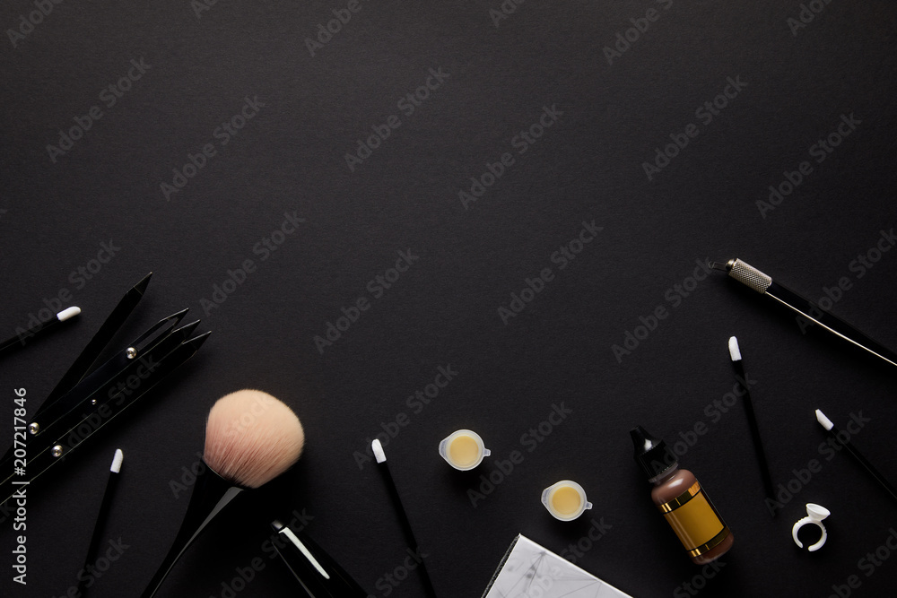 elevated view of tools for permanent makeup isolated on black