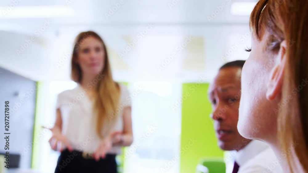 Female boss talks to business colleagues at informal meeting Female boss talks to business colleagues at informal meeting