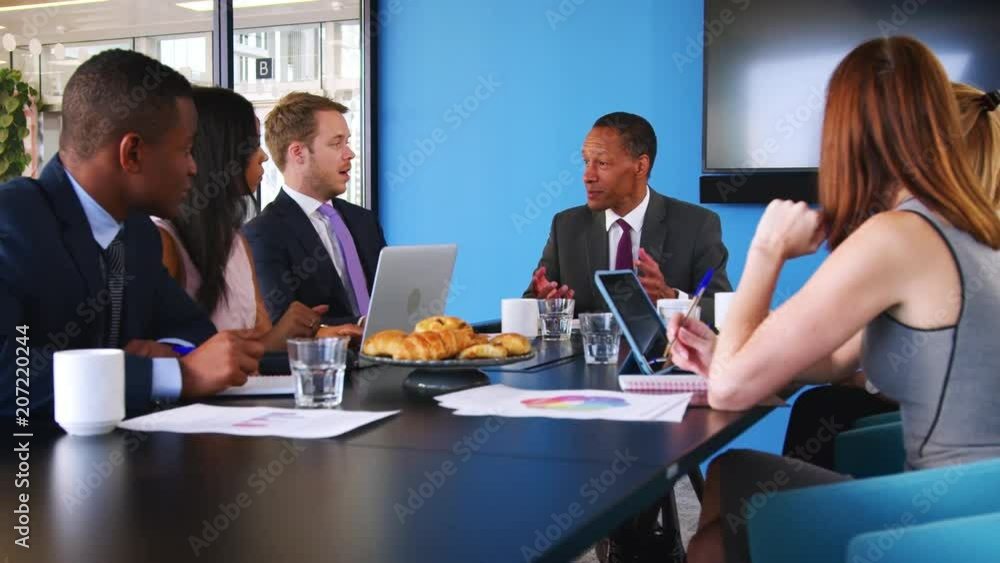 Business colleagues talking at a meeting Business colleagues talking at a meeting