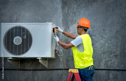 Technician is checking outdoor air conditioner unit