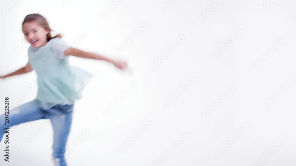 Young Girl Running And Jumping Against White Background Young Girl Running And Jumping Against White Background