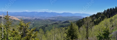 Panoramic view of Wasatch Front Rocky Mountains from the Oquirrh Mountains, by Kennecott Rio Tinto Copper mine, Utah Lake and Great Salt Lake Valley in early spring with melting snow and Cloudscape. U