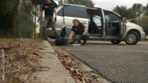 Wallpaper Mural Defocused crime scene with investigators working in the background. Torontodigital.ca