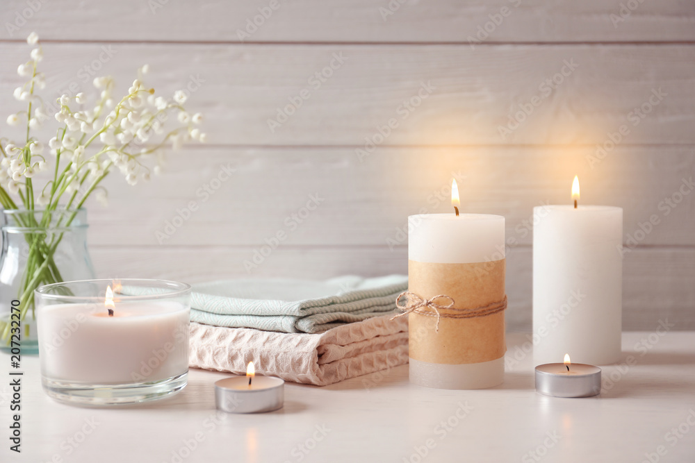 Beautiful composition with burning wax candles on table Beautiful composition with burning wax candles on table
