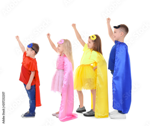 Cute children in superhero costumes on white background