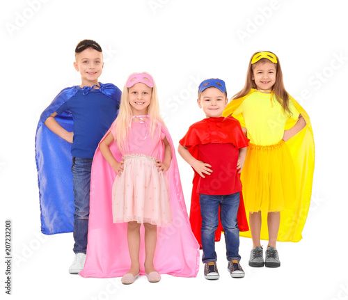 Cute children in superhero costumes on white background