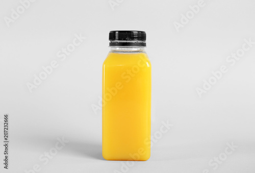 Bottle with delicious fresh juice on light background